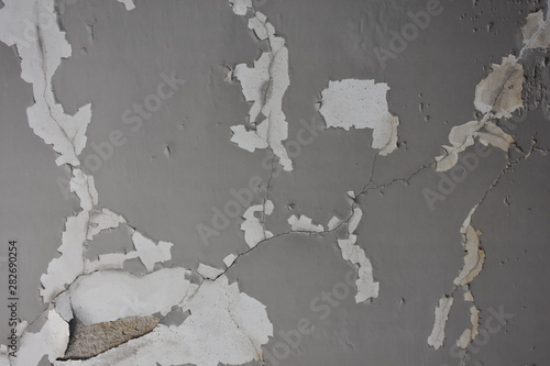 Detail of abandoned, run-down house wall. Ruined wall. background of an old dirty wall with gray paint
