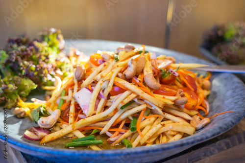 Thai spicy seafood mango salad. Food background.