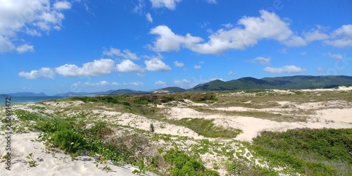 Sand dunes, mountains and the Atlantic Ocean seen from the Joaquina beach in Florianopolis, Brazil.