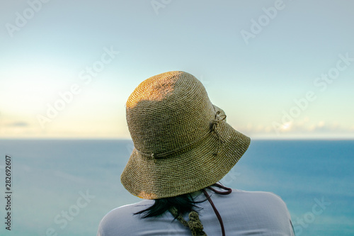 girl in the beach looking at the ocean