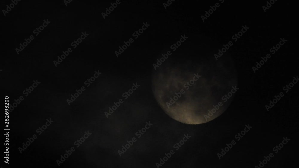 Moon With Clouds In The Night Sky. Concept of a spooky theme and mystery. Mysterious night sky with moon and dramatic clouds passing. Dark night with moon. Moon With Clouds In The Night Sky. Concept of a spooky theme and mystery. Mysterious night sky with moon and dramatic clouds passing. Dark night with moon.