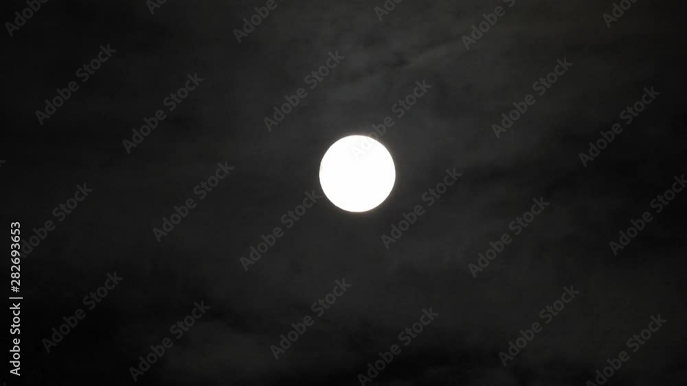 Moon With Clouds In The Night Sky. Concept of a spooky theme and mystery. Mysterious night sky with moon and dramatic clouds passing. Dark night with moon. Moon With Clouds In The Night Sky. Concept of a spooky theme and mystery. Mysterious night sky with moon and dramatic clouds passing. Dark night with moon.