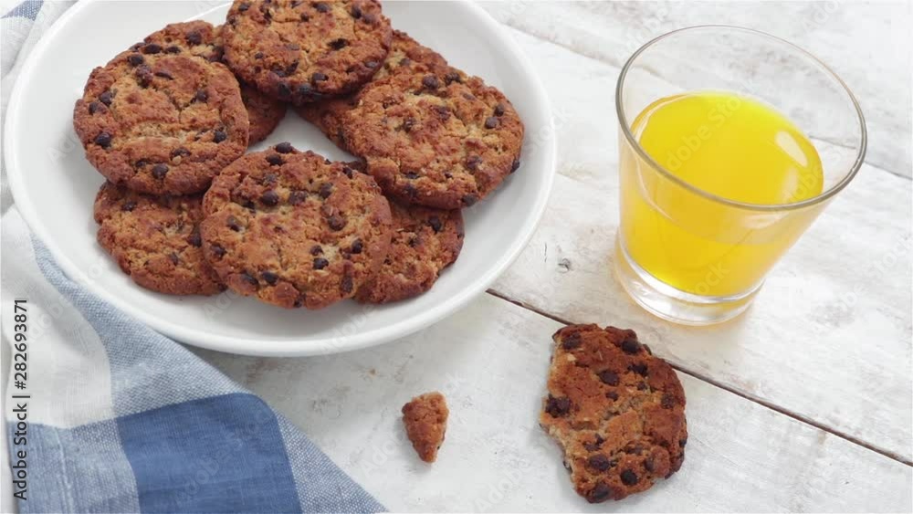man hand take chocolate cookie from plate man hand take chocolate cookie from plate