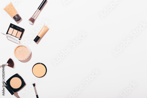 Flat lay side frame of cosmetic products for natural nude makeup