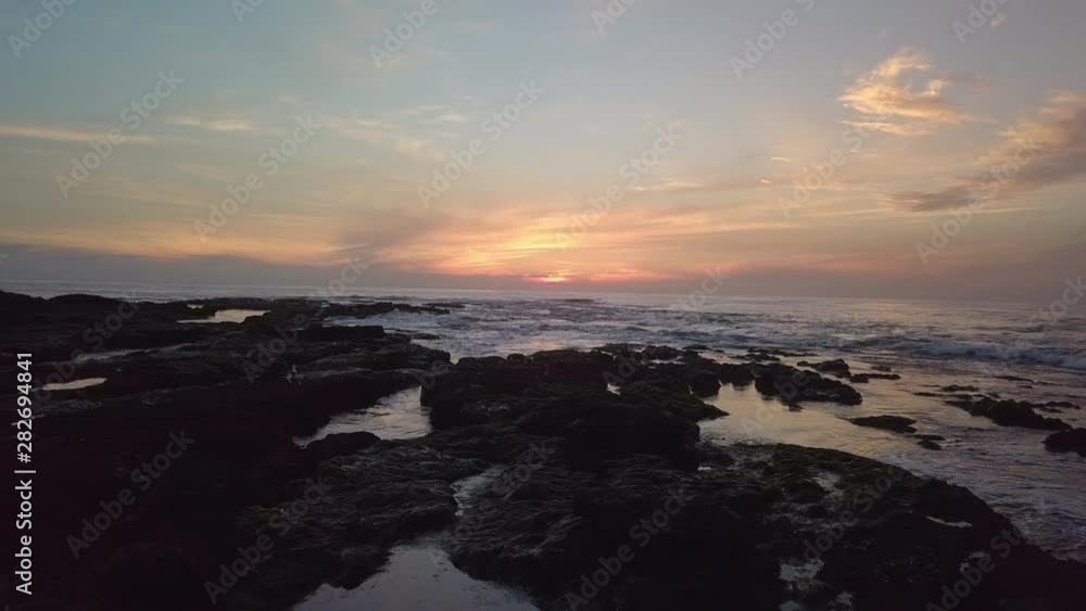 Aerial drone shot flying low over tide pools at sunset Aerial drone shot flying low over tide pools at sunset