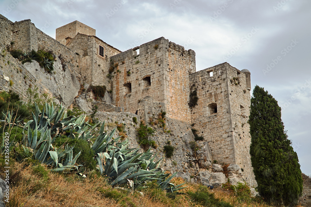 Stone walls of the medieval fortress Klis in Croatia.