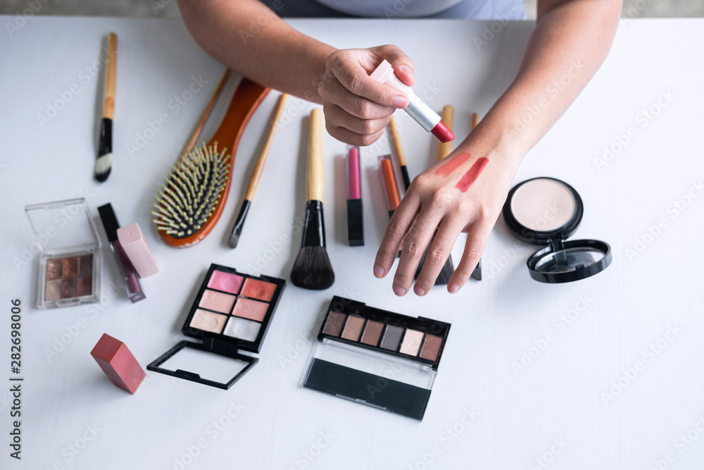 Elegant female Beauty blogger showing testing beauty cosmetic using product  makeup tutorial cosmetics and sale product Stock Photo | Adobe Stock