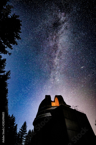 Milky way galaxy over observatory photo