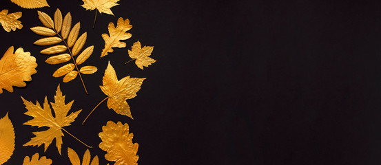 Flat lay creative autumn composition. Golden leaves on black background top view copy space. Fall concept. Autumn background. Minimal concept idea, floral design
