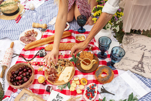 Checkered picnic blanket in french style with foods and sign says bon appetit