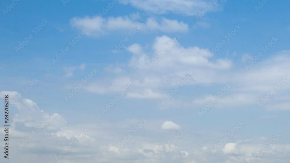 white fluffy clouds in the blue sky . time lapse white fluffy clouds in the blue sky . time lapse