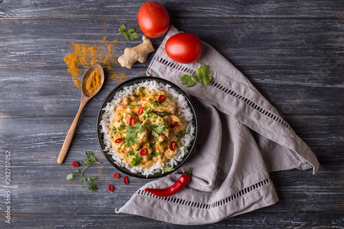 Top down view of a delicious chicken tikka masala with Indian spices and Basmati rice photo