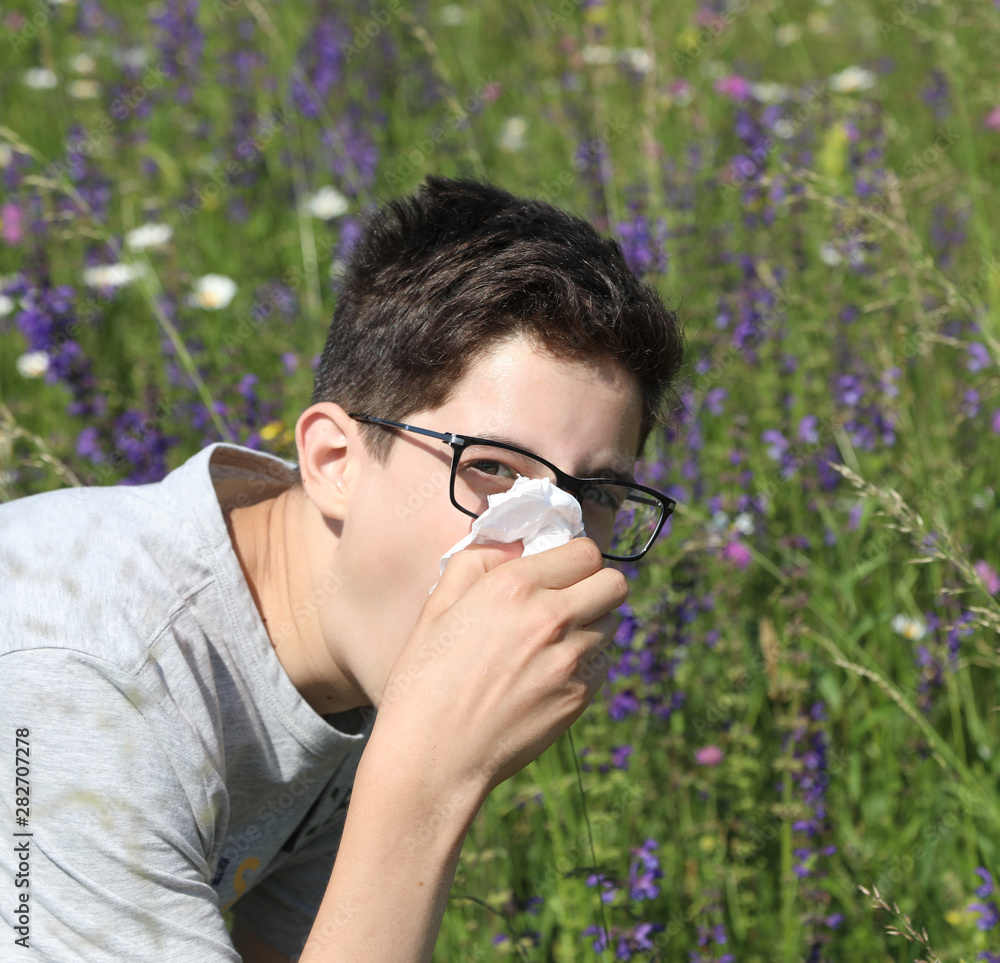 boy in the meadows with allergy in spring boy in the meadows with allergy in spring