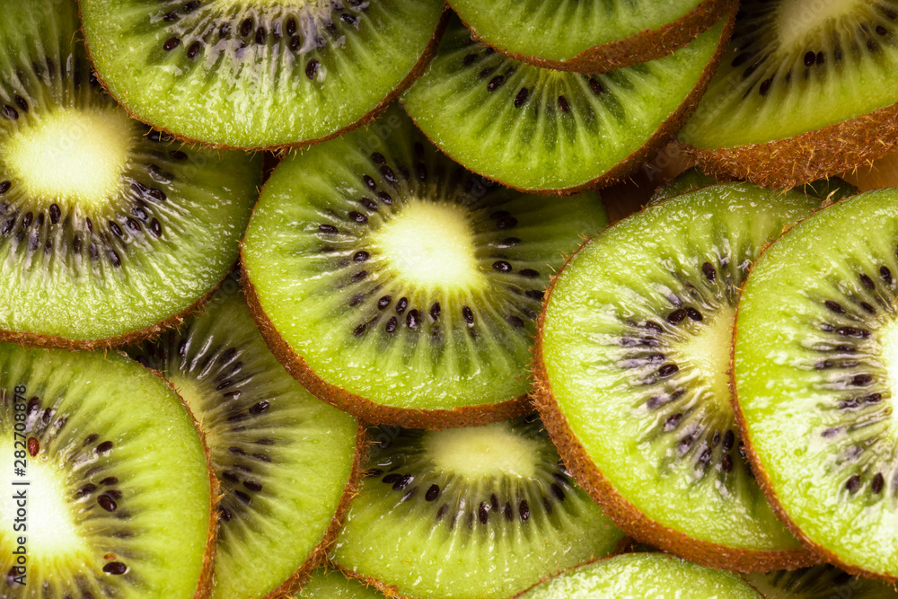 heap of fresh green kiwi slices background. top view heap of fresh green kiwi slices background. top view