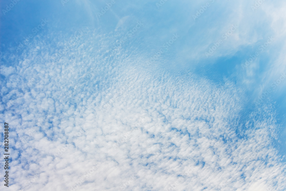 Blue sky with small white clouds, background for design_
