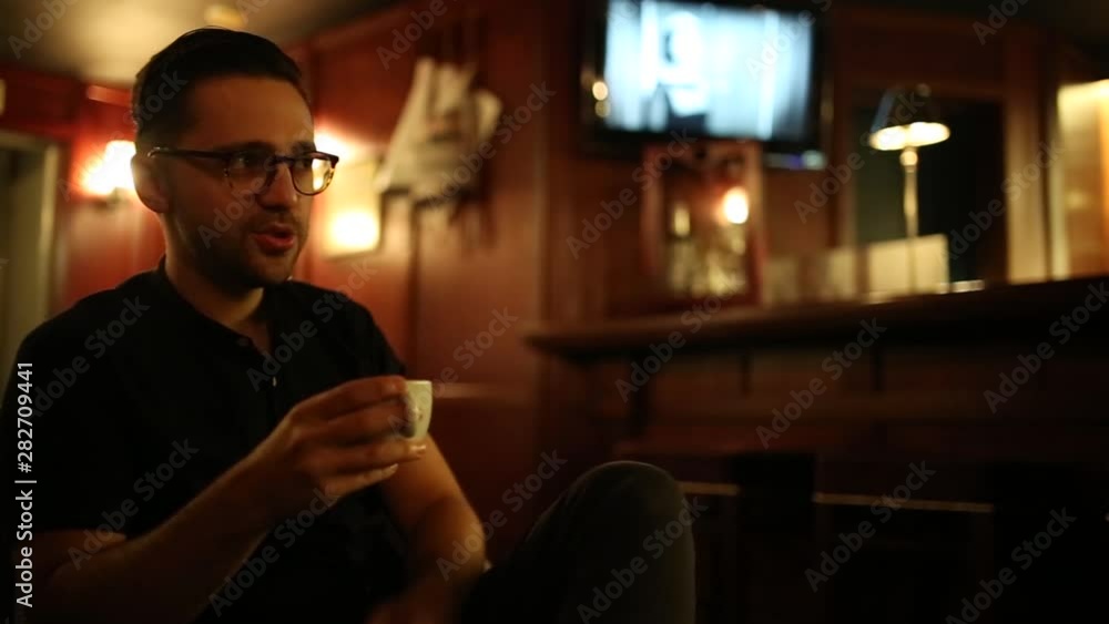 man in a retro bar drinks coffee in the evening. man in a retro bar drinks coffee in the evening.