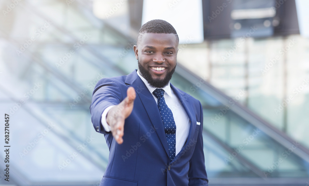 Confident Businessman Stretching Hand For Greeting In Urban Area Confident Businessman Stretching Hand For Greeting In Urban Area