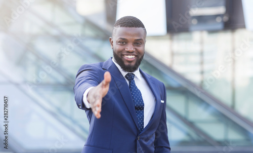 Confident Businessman Stretching Hand For Greeting In Urban Area