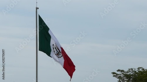 Mexican flag displayed over the Port of Puerto Vallarta, Mexico. Camera Fixed.