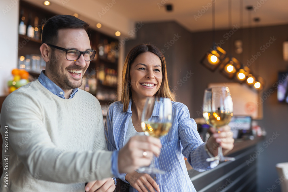 Couple raising glasses and making a toast Couple raising glasses and making a toast