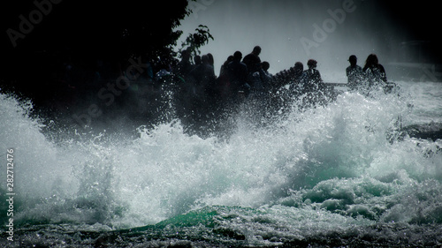 Photos Tourists at the roaring waters of the Rhine Falls near Schaffhausen