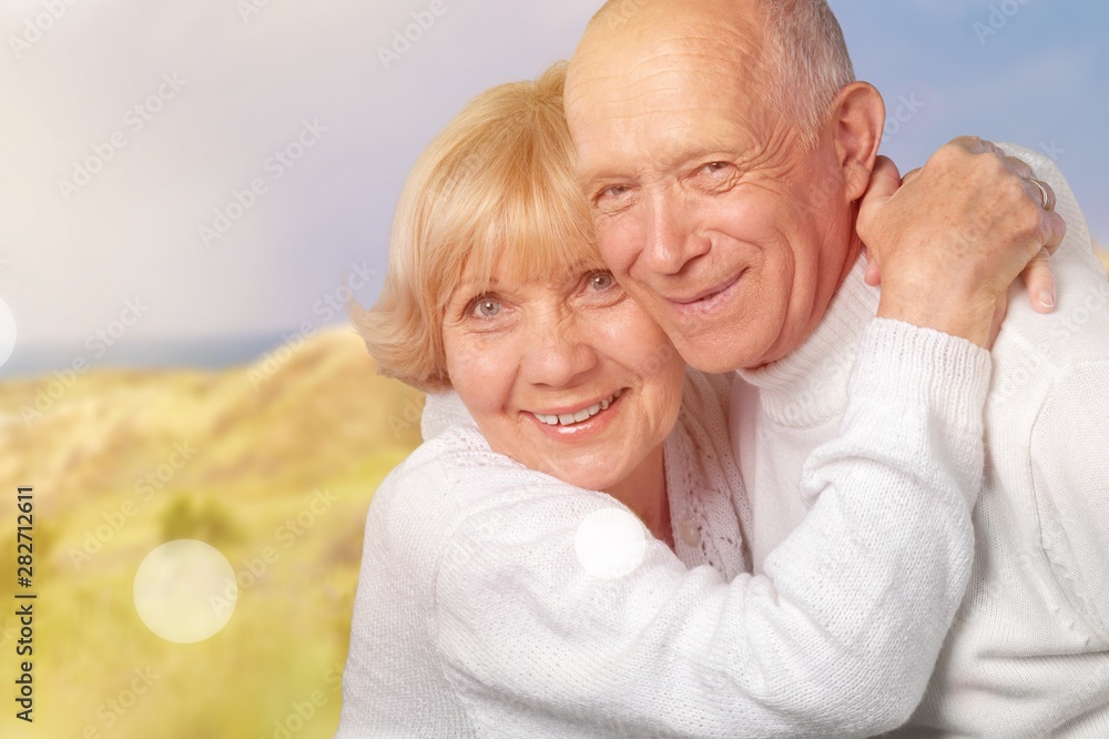 Portrait of happy senior couple smiling at home