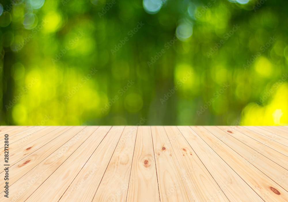 Wood table top on blurred green background Wood table top on blurred green background