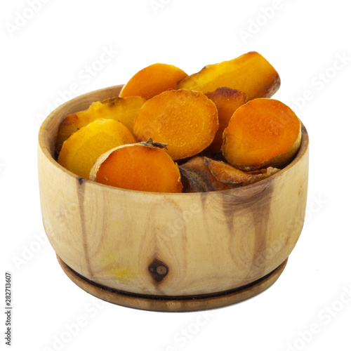 heap of turmeric in wooden cup isolated on white background photo