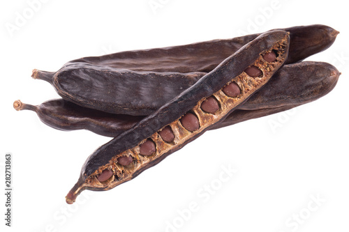 heap of carob pods isoalted on white background