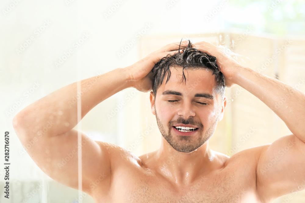 Handsome man washing hair at home Handsome man washing hair at home