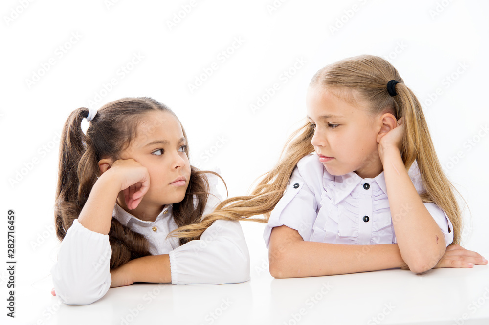 Adorable schoolgirls. Back to school. Education concept. Beautiful girls best friends. Formal style. Happy childhood. Schoolgirls sit at desk white background. Schoolgirls emotional friends Adorable schoolgirls. Back to school. Education concept. Beautiful girls best friends. Formal style. Happy childhood. Schoolgirls sit at desk white background. Schoolgirls emotional friends