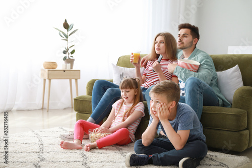 Family watching TV at home