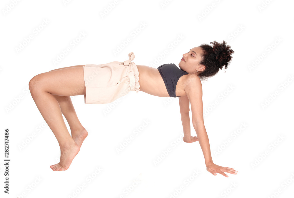 Slim young woman building a bridge with her body Slim young woman building a bridge with her body