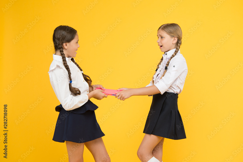Schoolgirls fight for book. Protect property. Greedy friends. Greedy competitors. Jealous friend. Greedy kids concept. Sisters relations issues. Share book with friend. Classmates rivalry problem Schoolgirls fight for book. Protect property. Greedy friends. Greedy competitors. Jealous friend. Greedy kids concept. Sisters relations issues. Share book with friend. Classmates rivalry problem