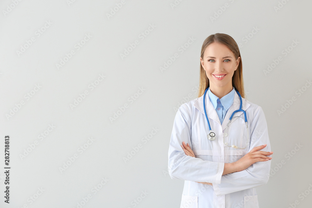 Female doctor with stethoscope on light background Female doctor with stethoscope on light background