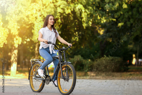 Young woman riding bicycle outdoors