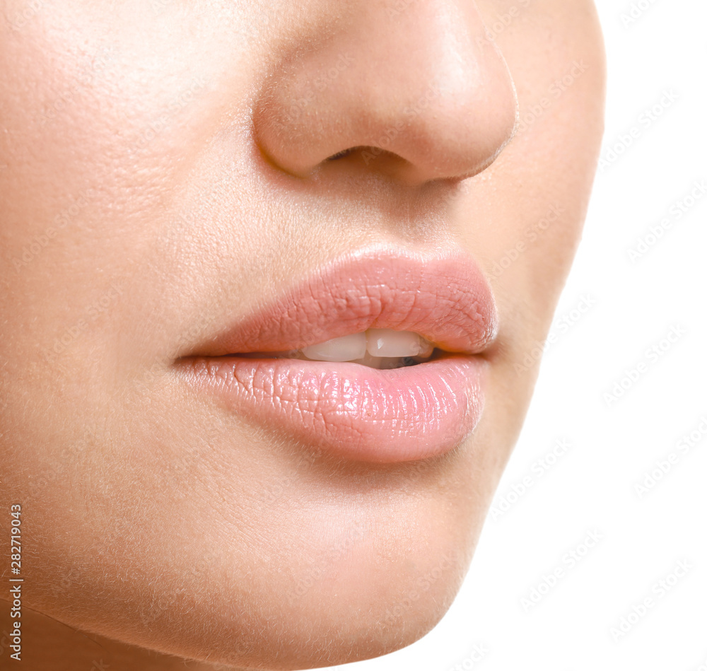 Fototapeta premium Young woman with beautiful lips on white background, closeup