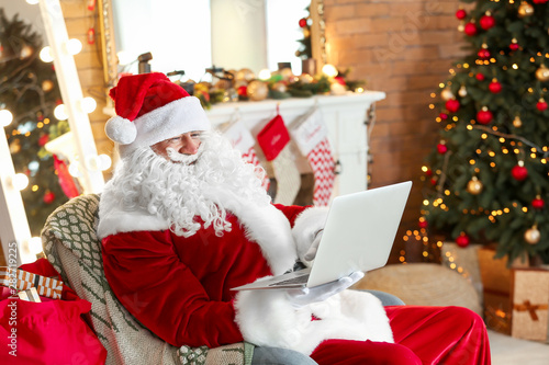 Santa Claus with laptop in ...