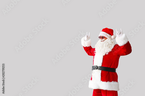 Portrait of cool Santa Claus on light background