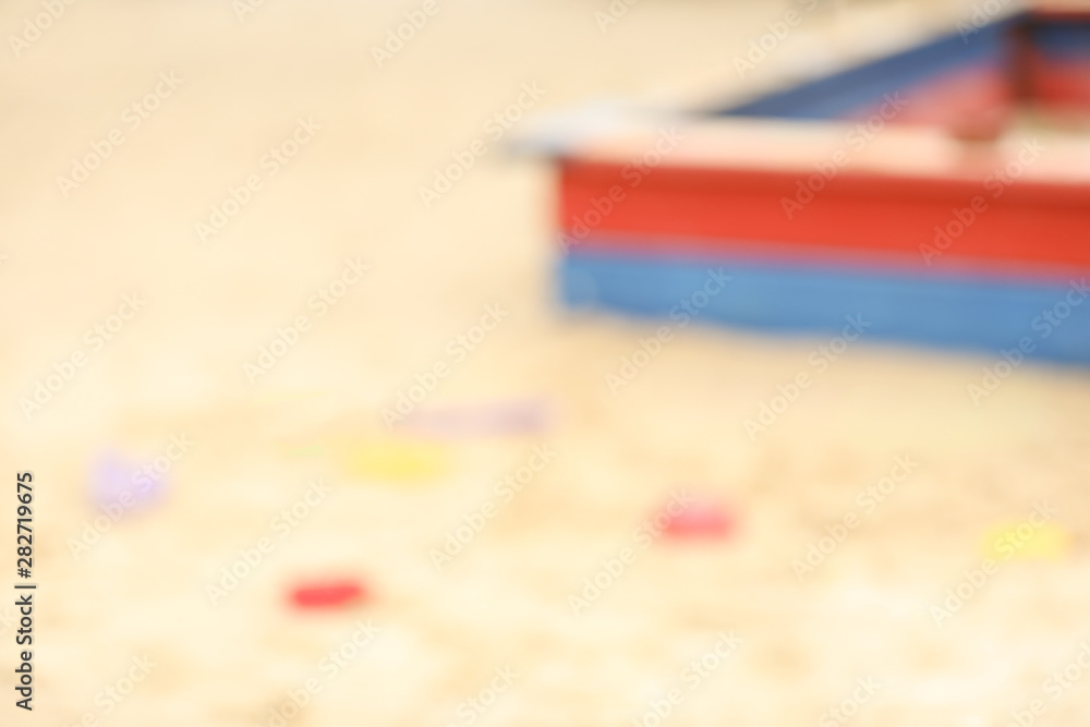 Blurred view on sandpit with toys outdoors Blurred view on sandpit with toys outdoors
