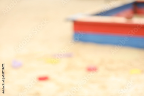 Blurred view on sandpit with toys outdoors