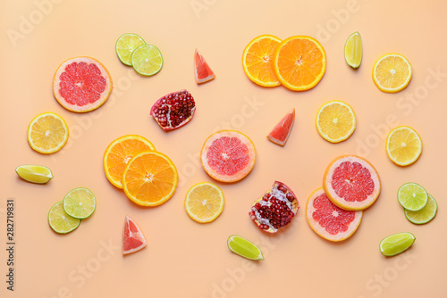 Fototapeta Naklejka Na Ścianę i Meble -  Different sliced citrus fruits on color background