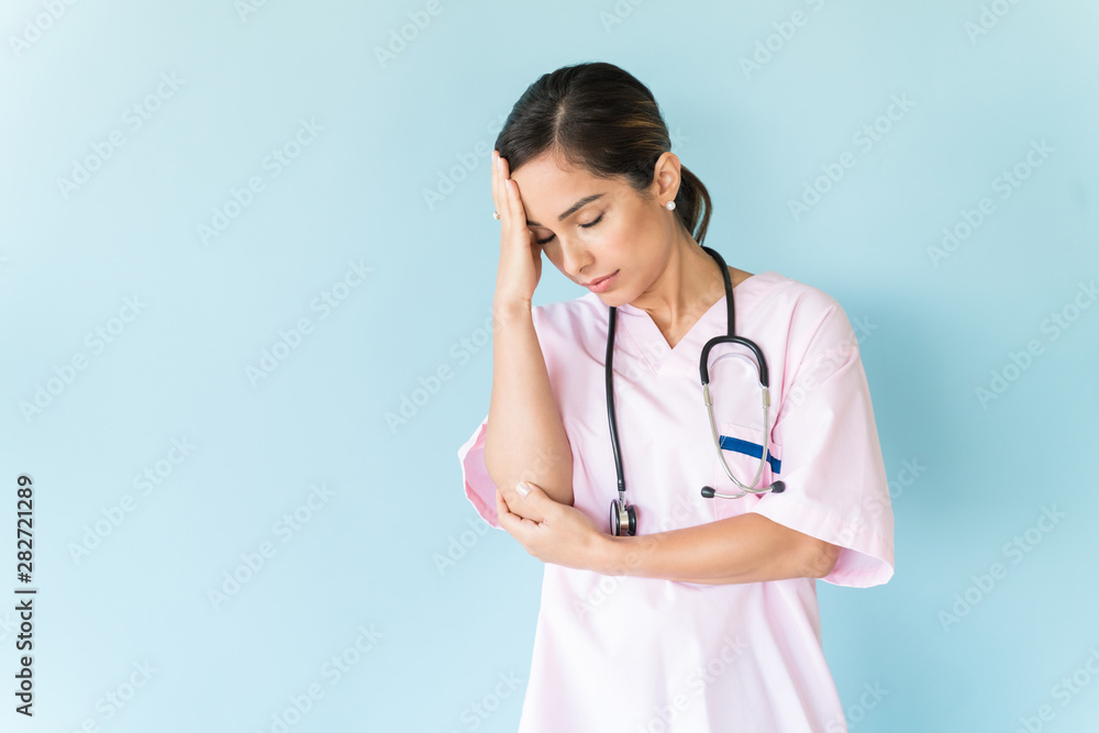 Stressed Professional Wearing Scrubs In Studio Stressed Professional Wearing Scrubs In Studio