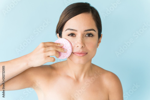 Beautiful Woman Is Scrubbing Face Against Colored Background
