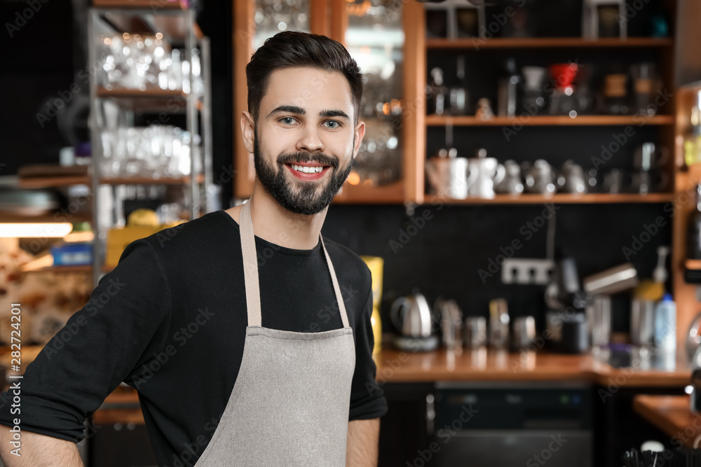 Portrait of smiling barista in coffee shop. Space for text Portrait of smiling barista in coffee shop. Space for text