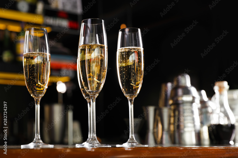 Glasses of champagne on counter in bar. Space for text Glasses of champagne on counter in bar. Space for text