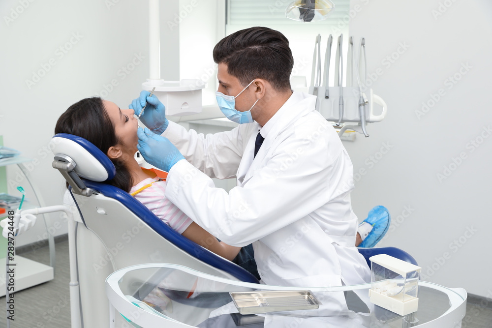Professional dentist working with patient in clinic Professional dentist working with patient in clinic