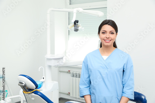 Portrait of professional female dentist in clinic. Space for text