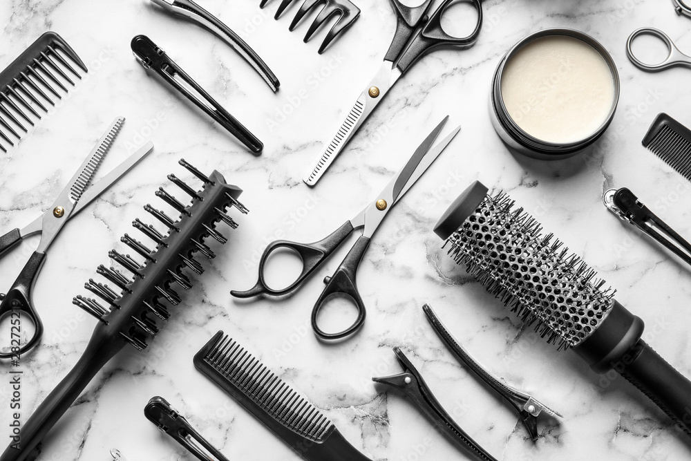 Flat lay composition with scissors and other hairdresser's accessories on white marble background - obrazy, fototapety, plakaty 