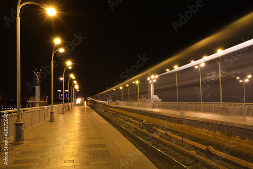 Night metro railroad with illumination in modern city